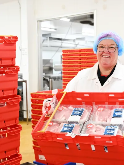 A Blakemore Meats staff member holding some fresh meat products ready to be sent to store.
